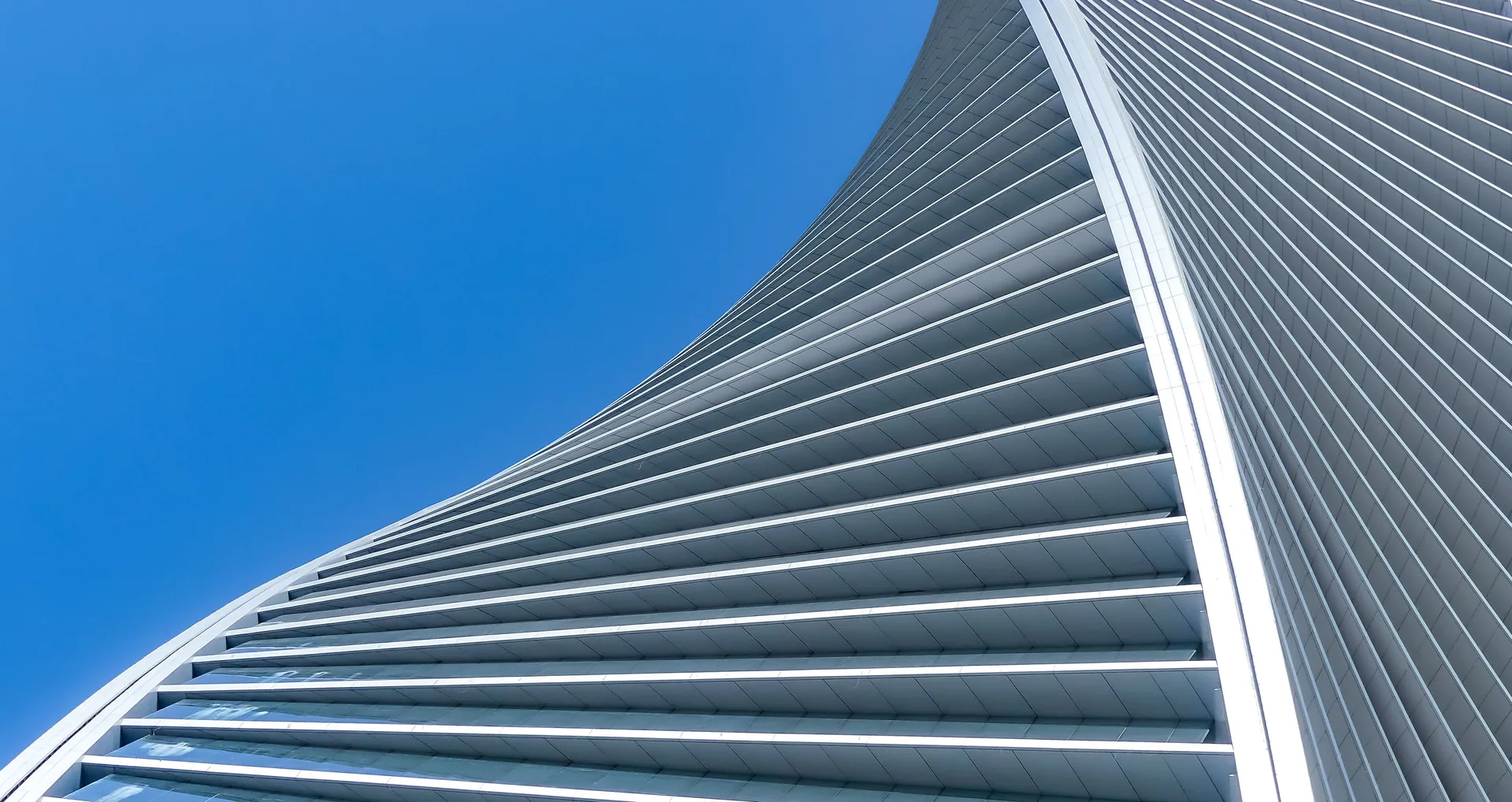 Modern metal facade beneath a blue sky